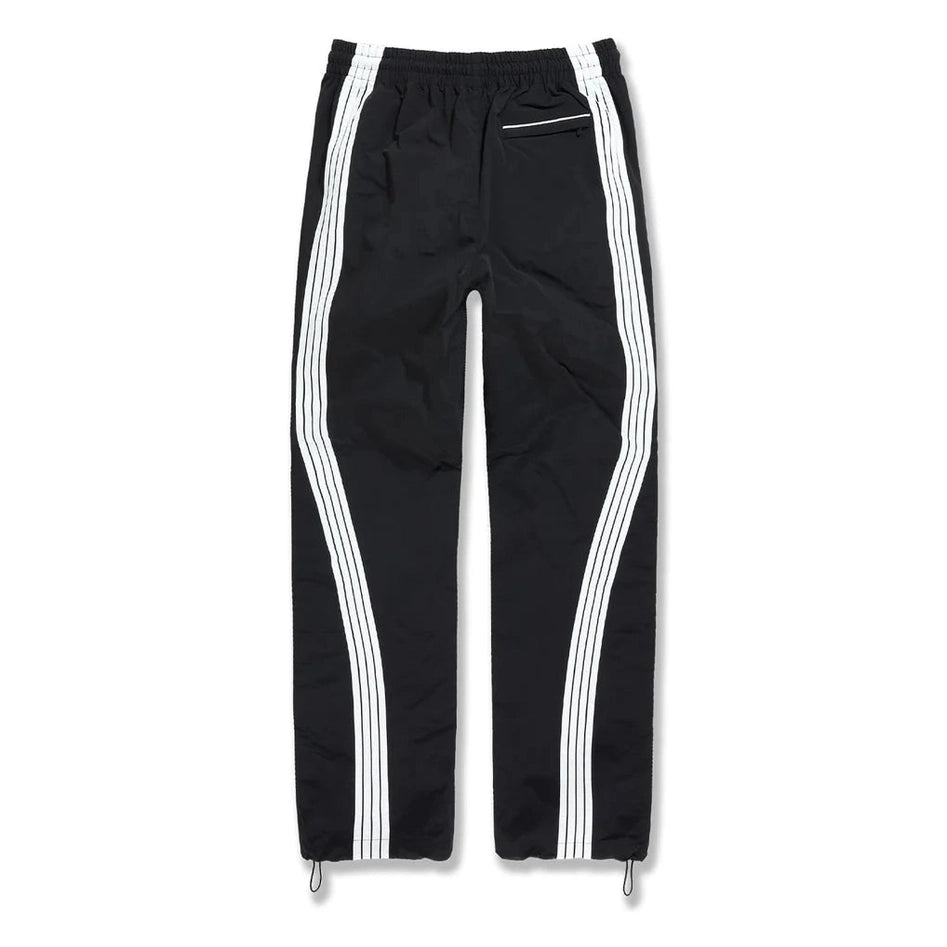 Back view of black mens track pants featuring white side stripes, elastic waistband, zip pocket, and adjustable drawstring cuffs.