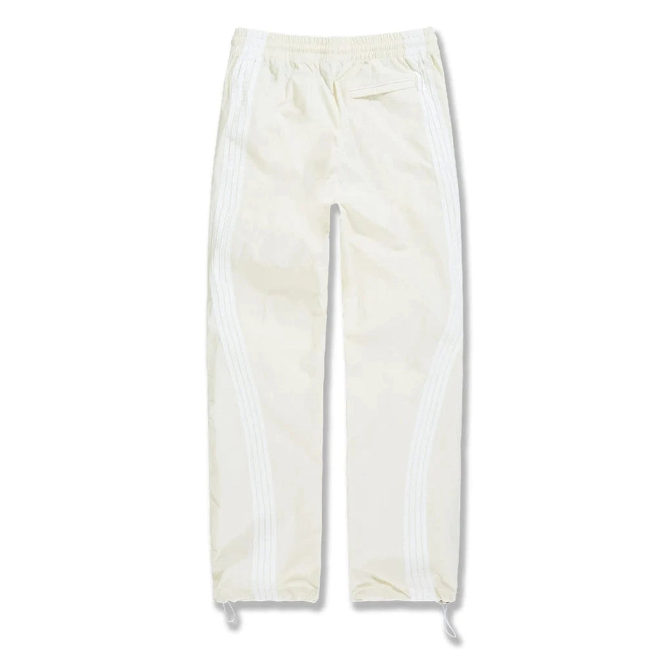 Back view of cream Big Mens The Beautiful Game track pants featuring white side stripes, elastic waist, back pocket, and drawstring cuffs.