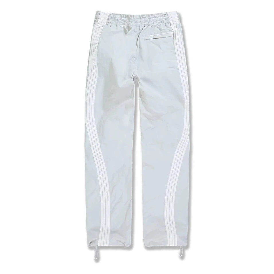 Back view of white big mens track pants featuring side stripes, elastic waist, and water-resistant polyester fabric.