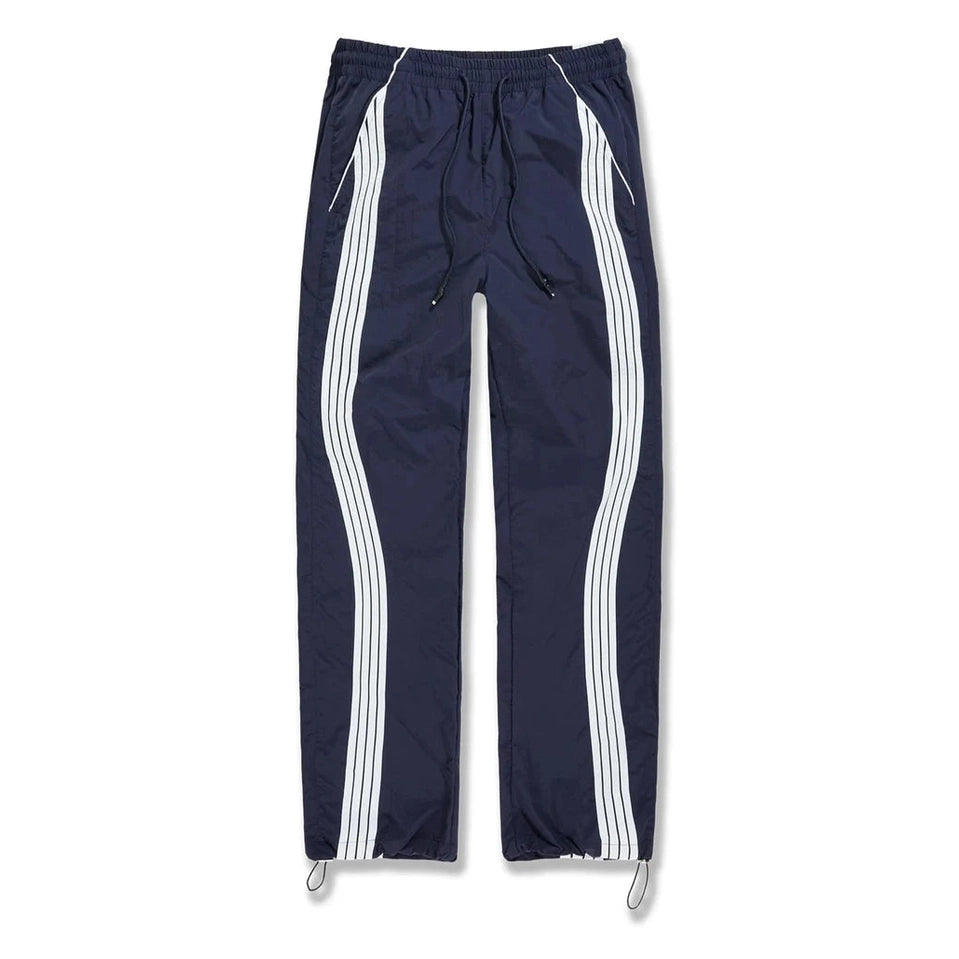 Navy blue track pants with white side stripes, elastic waist with drawstring, and water-resistant polyester fabric for active wear.